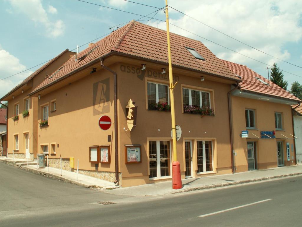 a large building on the corner of a street at Asso Penzion in Bojnice