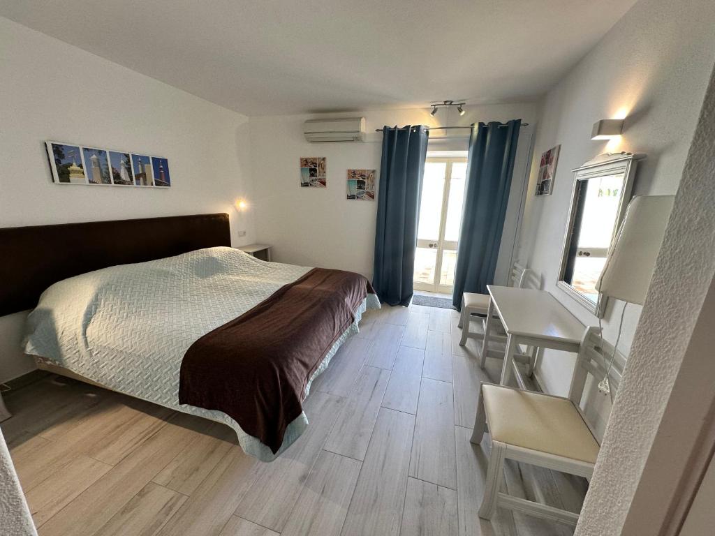 Postel nebo postele na pokoji v ubytování Luz Beach Apartments