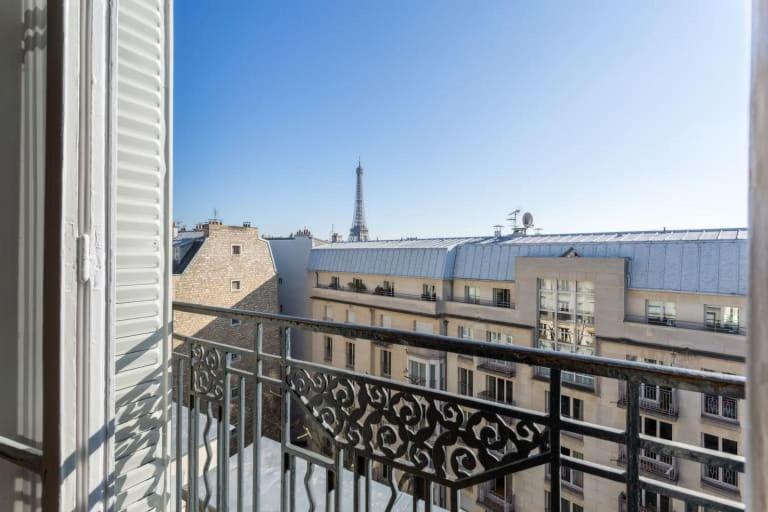 a view of a building from a balcony at GuestReady - Designer Apartment - Eiffel Tower View! in Paris