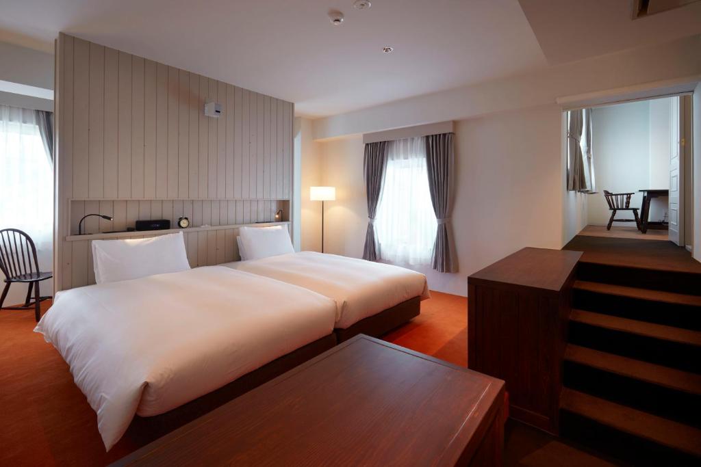 Кровать или кровати в номере Matsumoto Hotel Kagetsu