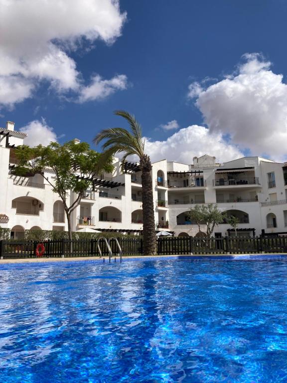 a large swimming pool in front of a building at Arty Apartment - La Torre Golf Resort in Torre-Pacheco