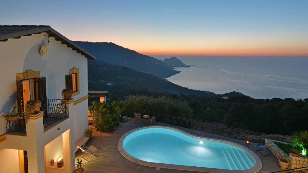 a swimming pool on the side of a house at Villa Il Basto 8 by Massimo Villas in SantʼAmbrogio