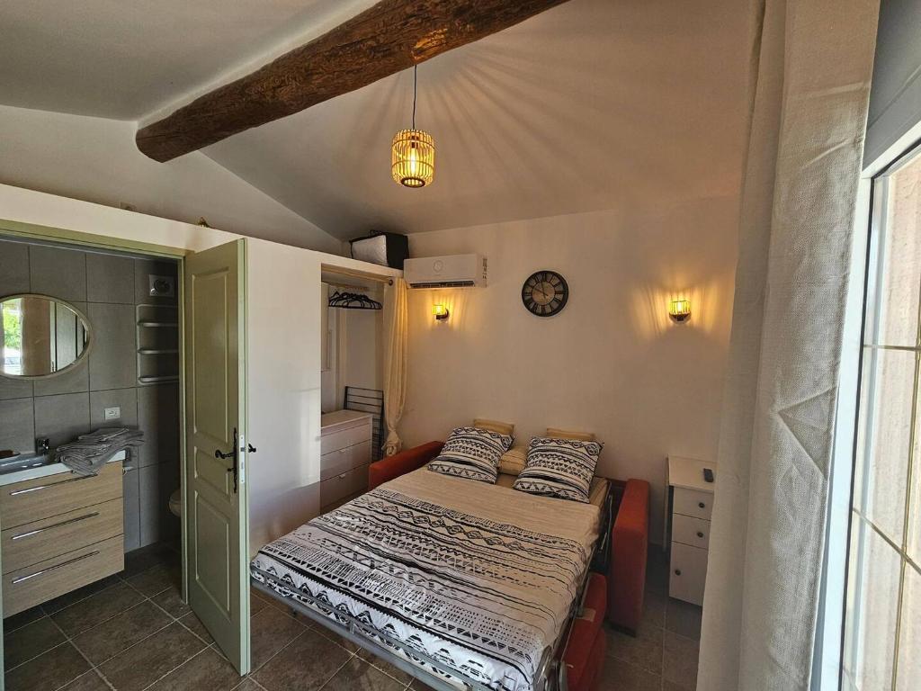 a small bedroom with a bed and a sink at Studio Vu sur l'O2 Là in La Motte