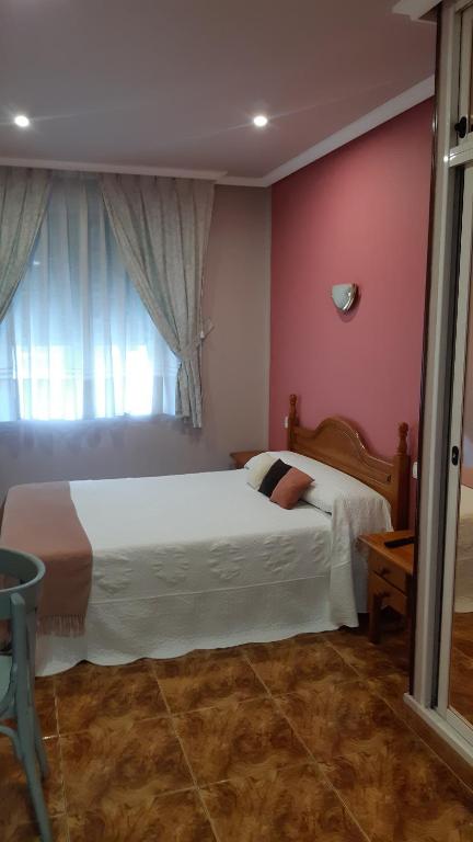Postel nebo postele na pokoji v ubytování Hostal pachin