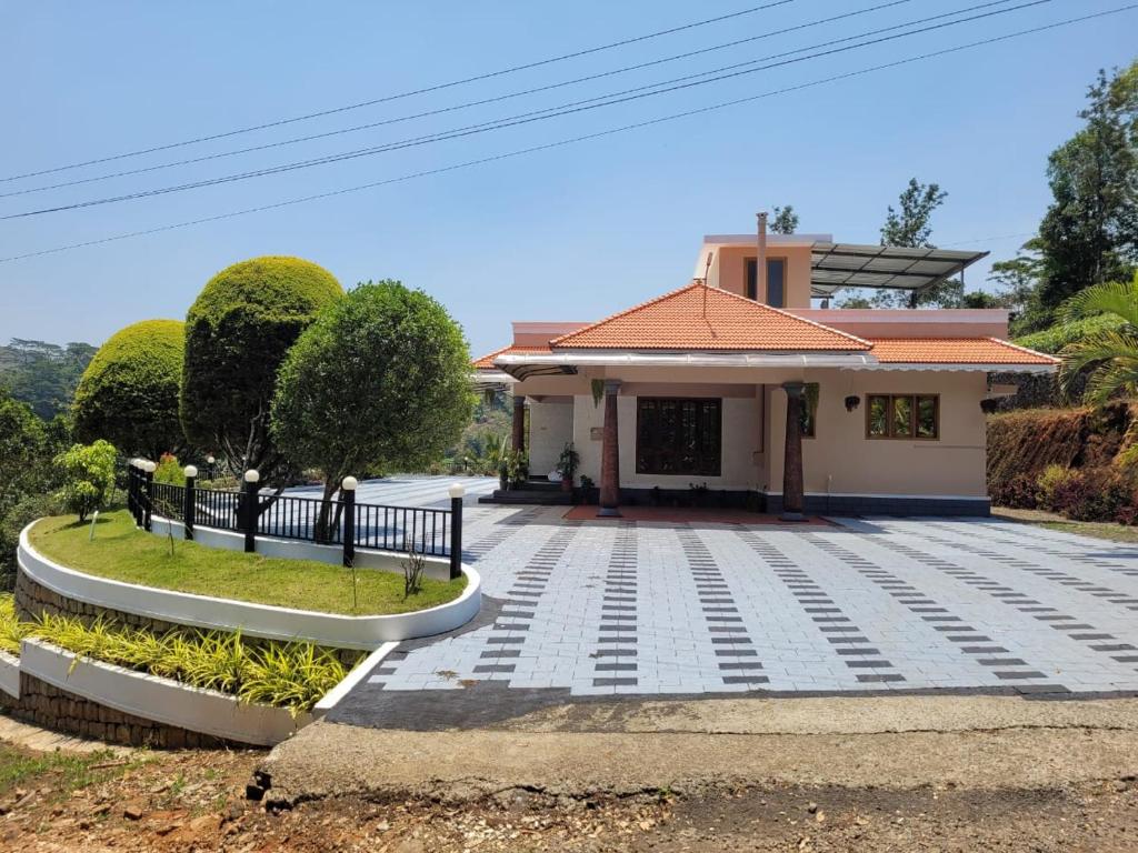 a house with a walkway in front of it at Tea Mitra Holiday Homes in Vagamon