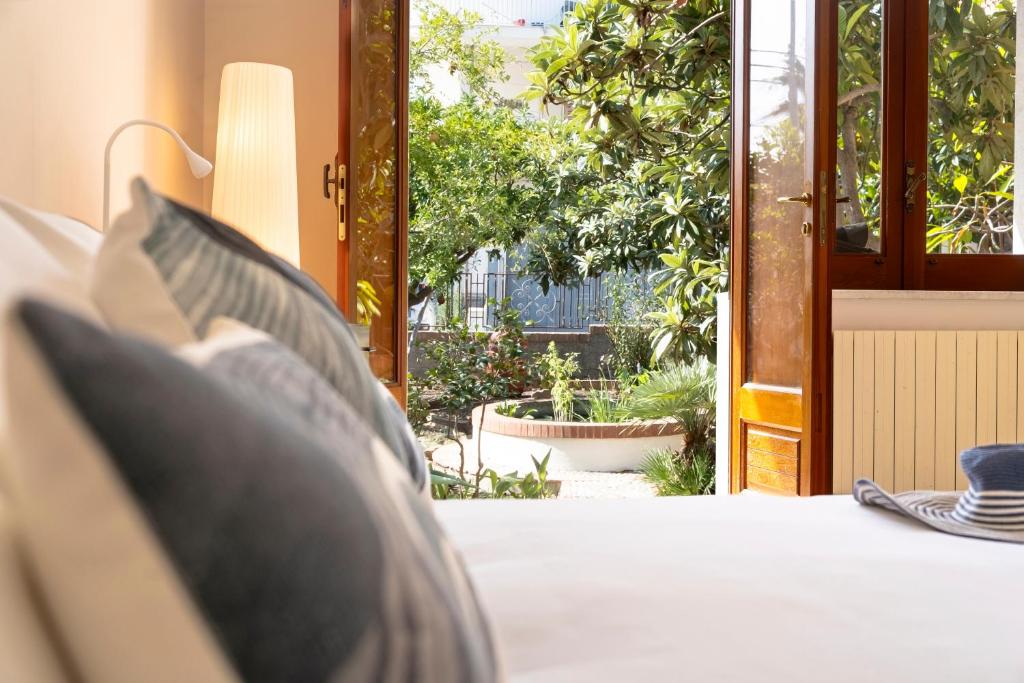 a bedroom with a bed and an open door at L'Arancio e i Pesci Rossi in Calatabiano