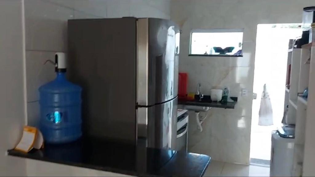 a kitchen with a stainless steel refrigerator and a sink at Casa de praia Jauá in Camaçari