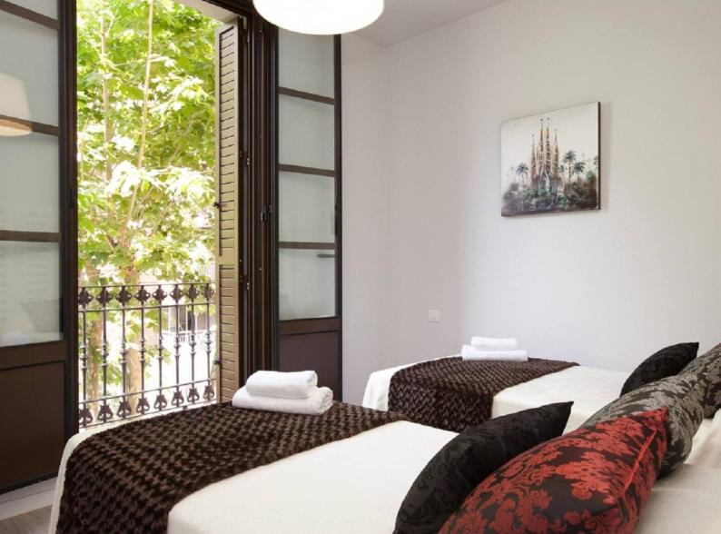 Postel nebo postele na pokoji v ubytování APBCN Eixample Center
