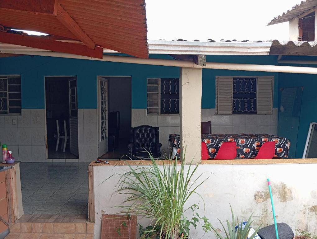 a blue house with a porch with a couch at Casa de Fundo da Martinha in Campinas