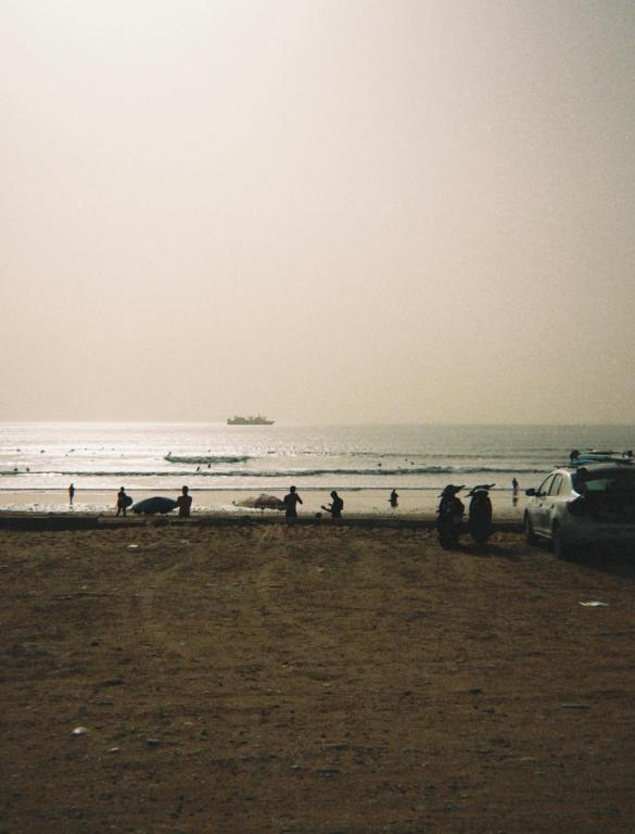 a group of people standing on the beach at Surf and Stay Anza - Surf Territory in Agadir
