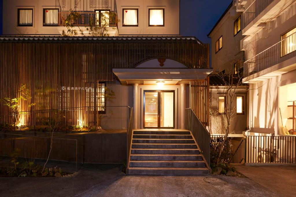 a staircase leading to a house at night at Matsumoto Hotel Kagetsu in Matsumoto
