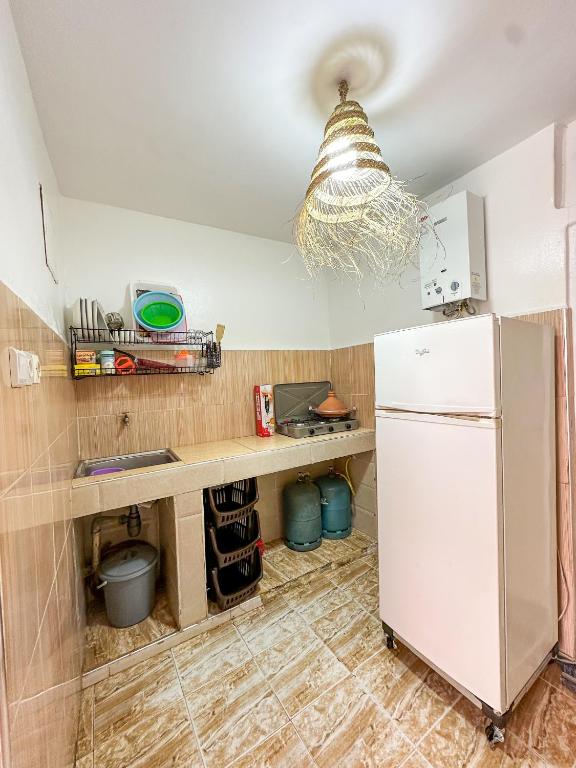 a kitchen with a white refrigerator and a counter at Surf and Stay Anza - Surf Territory in Agadir