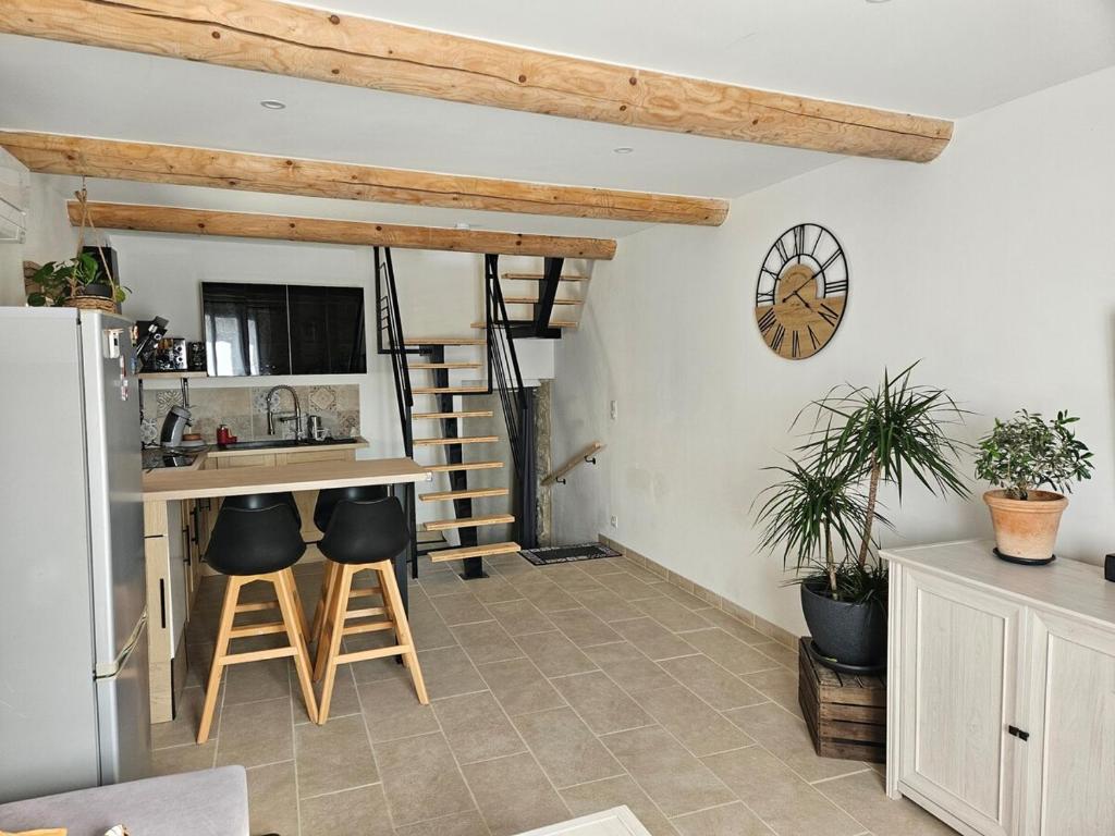 a kitchen with a counter and stools in a room at LA VASIO Hypercentre Vaison-la-Romaine - Air-conditioned in Vaison-la-Romaine