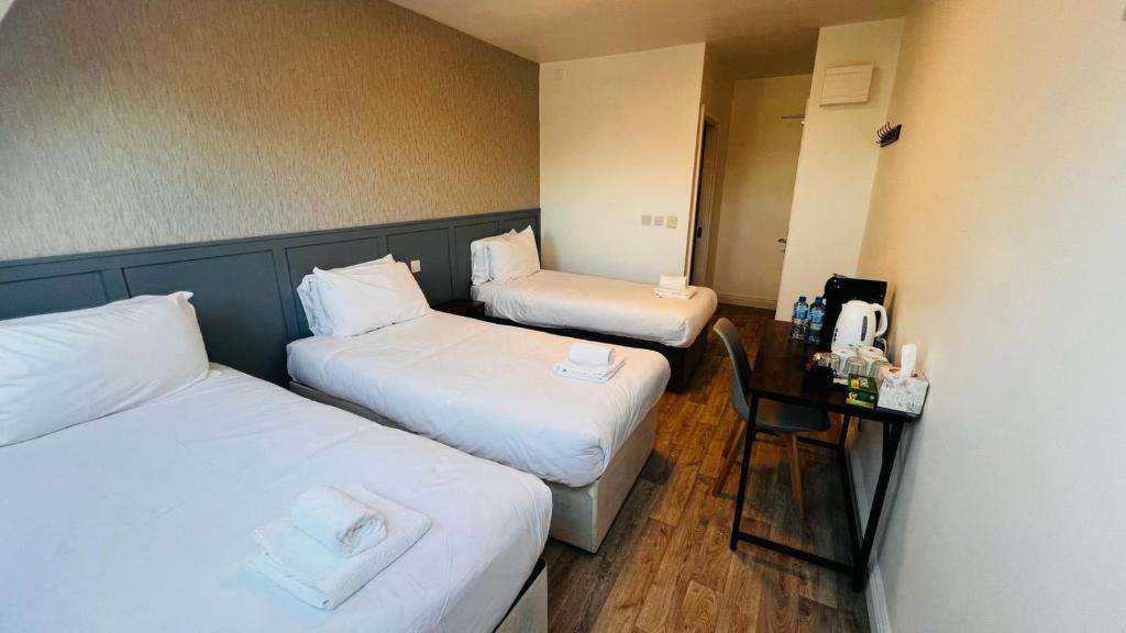 Postel nebo postele na pokoji v ubytování Mulligan Hotel