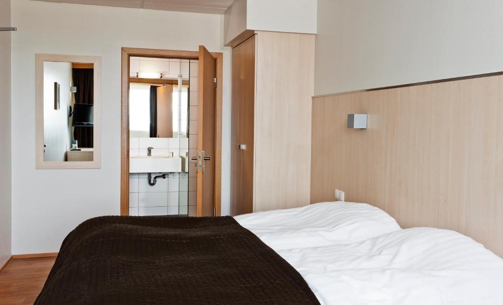 Postel nebo postele na pokoji v ubytování Hotel Klettur