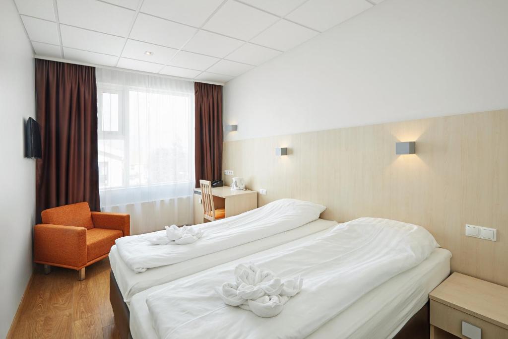 Postel nebo postele na pokoji v ubytování Hotel Klettur
