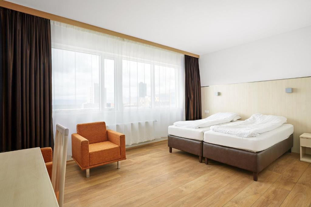 Postel nebo postele na pokoji v ubytování Hotel Klettur