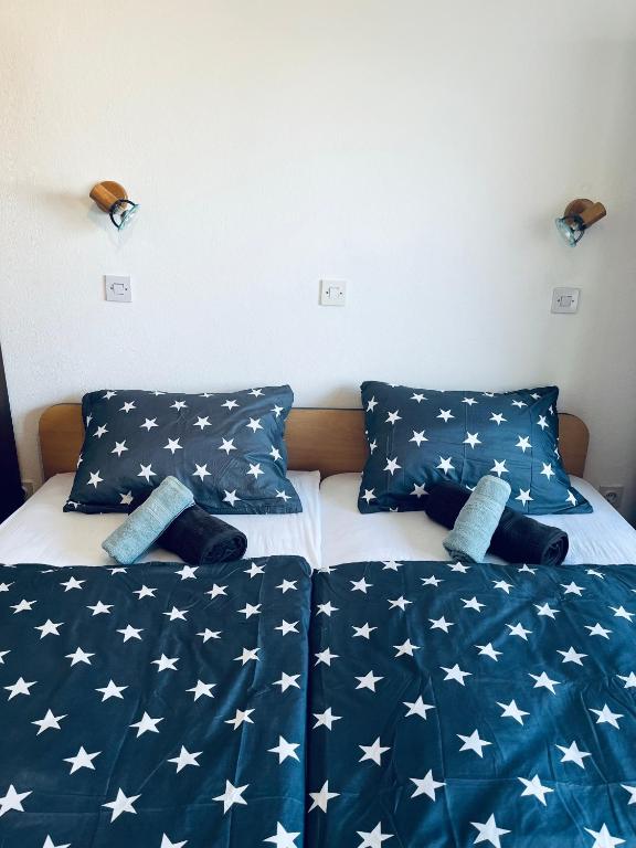 two beds in a bedroom with an american flag bedspread at Apartma Špan in Zgornje Gorje
