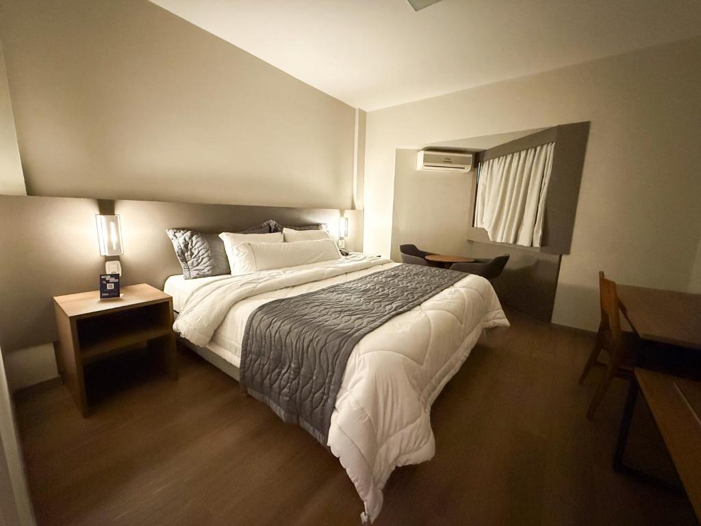 Postel nebo postele na pokoji v ubytování Hotel Caiuá