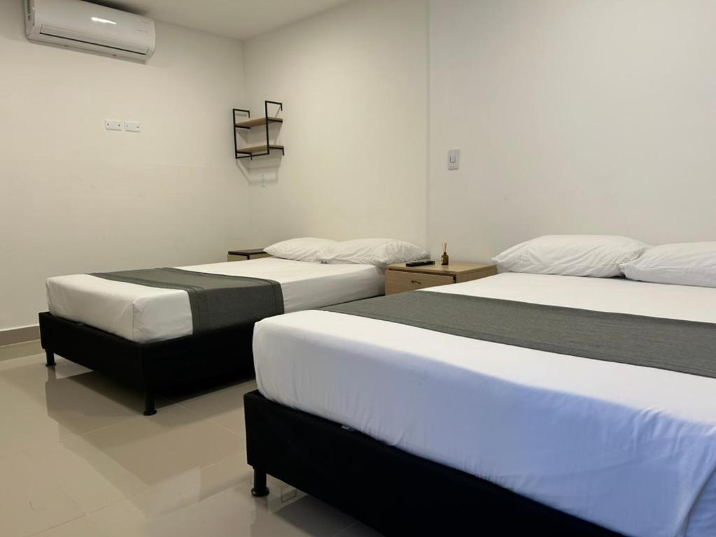 Postel nebo postele na pokoji v ubytování Hotel 79 Poblado