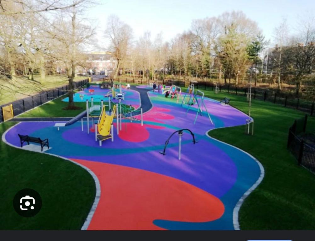 a park with a playground with a slide and slides at 4 star Rating 2 bed Newly renovated city apartment with free parking in Belfast