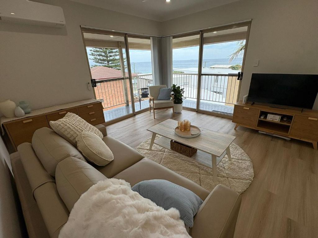 a living room with a couch and a television at Bunbury Ocean Views in Bunbury
