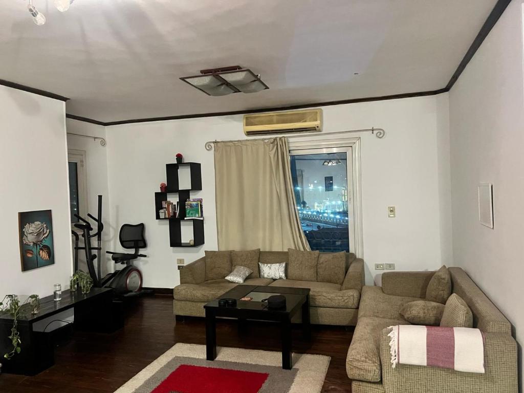 a living room with a couch and a table at Aqua Maadi Degla Group 199 in Cairo