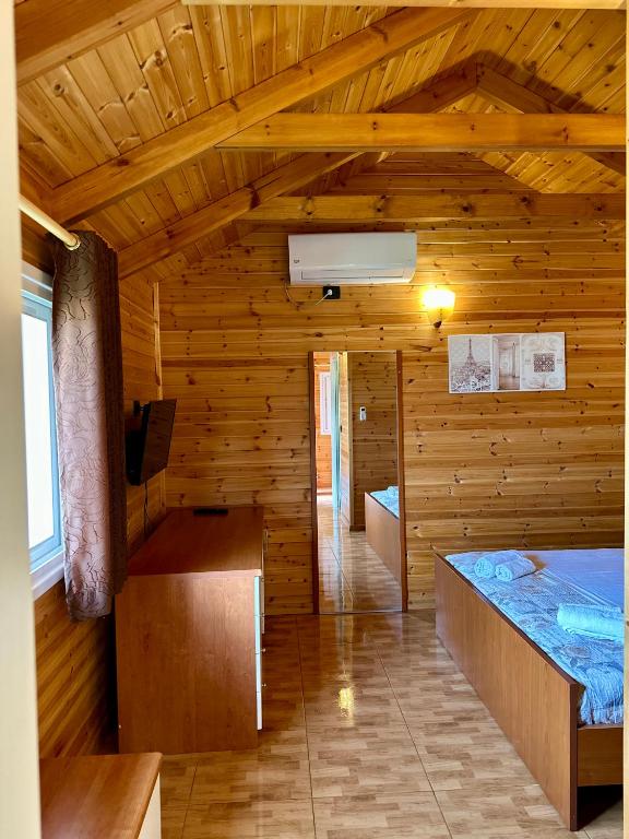 a room with a wooden room with a bed in it at The Mussel House in Ksamil