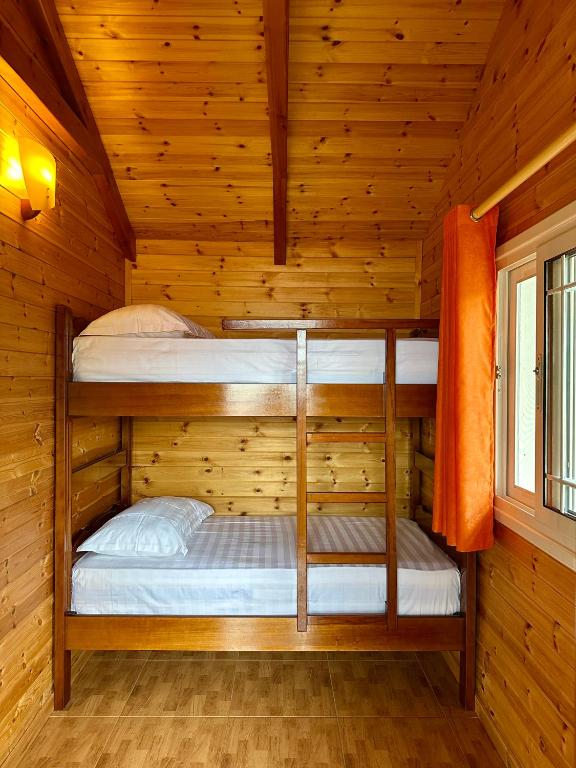 two bunk beds in a wooden cabin at The Mussel House in Ksamil