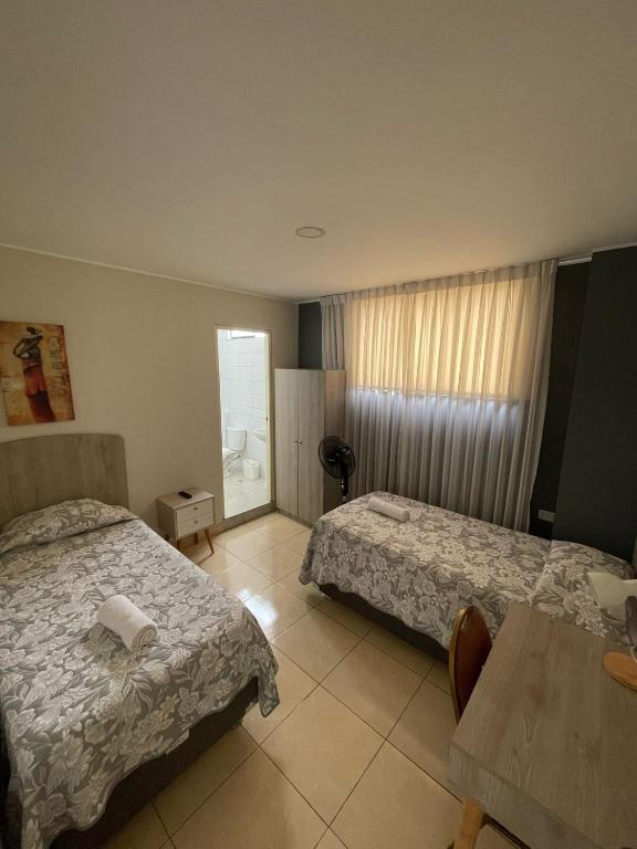 Postel nebo postele na pokoji v ubytování Casa Las Flores Ica