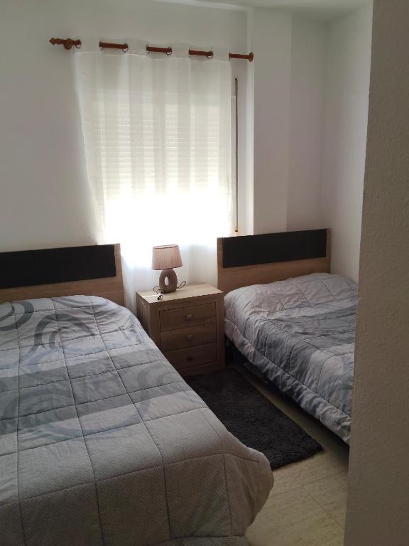 A bed or beds in a room at Relax en la playa