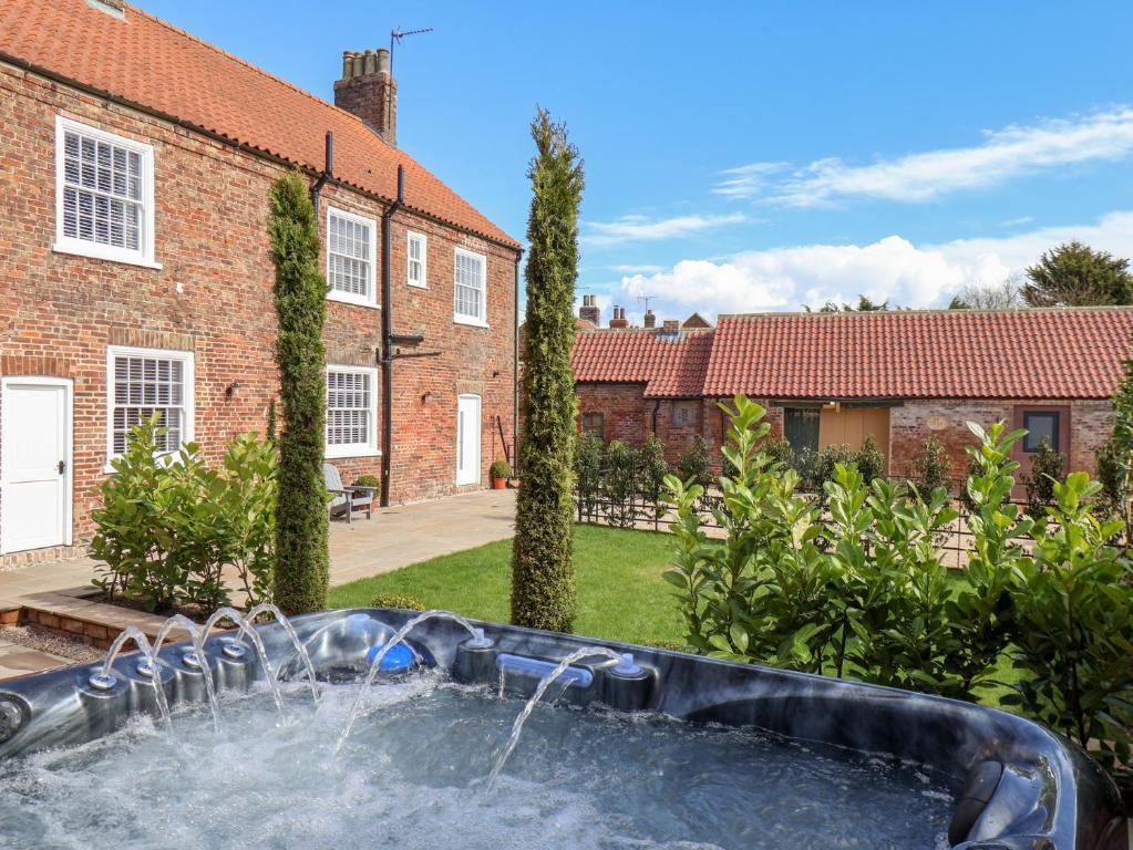a pool in the backyard of a house at Harpham Manor House in Lowthorpe