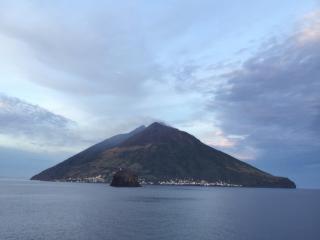 a mountain in the middle of a body of water at Schicciolina in Stromboli