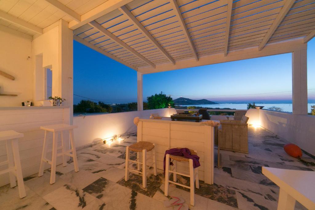 a patio with a bar and stools on a balcony at Seaside stays and tours in Naxos, Greece in Naxos Chora