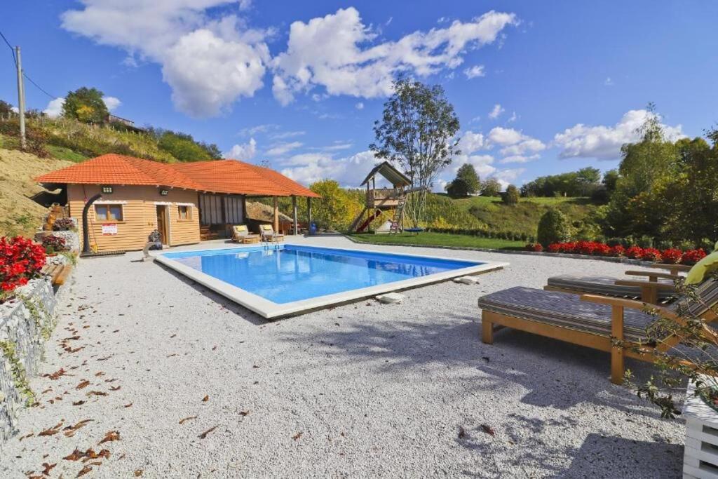 a swimming pool in a yard with a house at House Grga in Gornja Voća