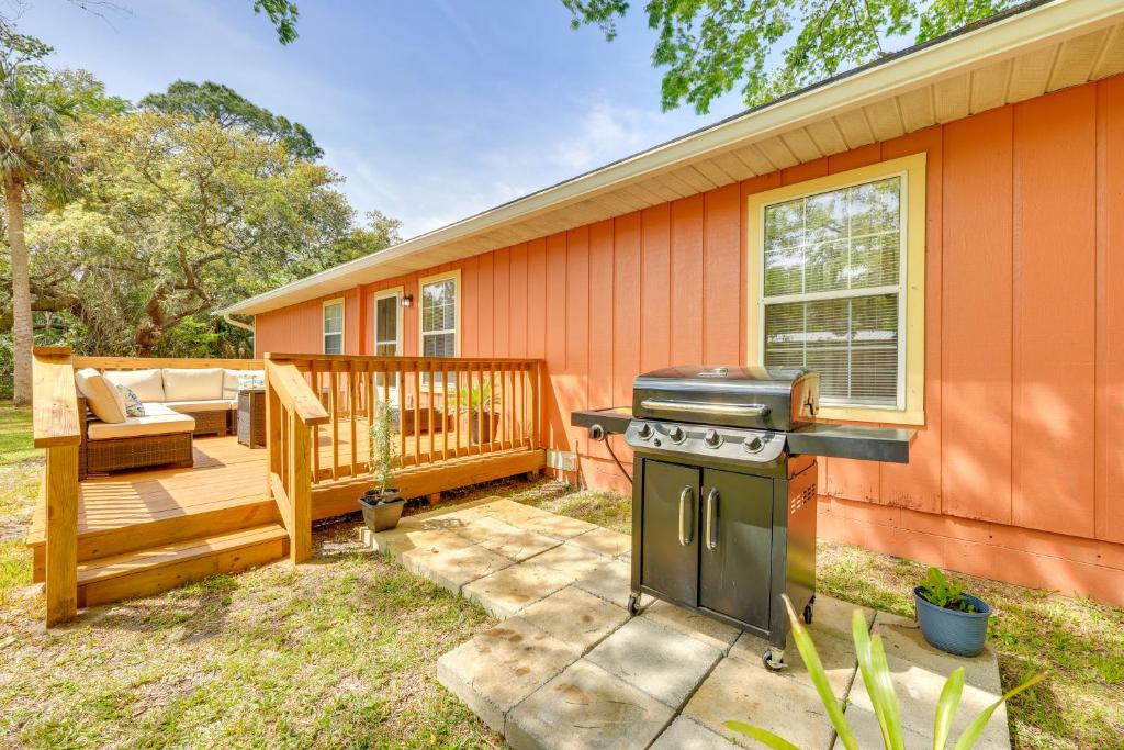 a backyard with a grill and a house at 2 Mi to Dtwn Home with Game Room in St Augustine! in Saint Augustine