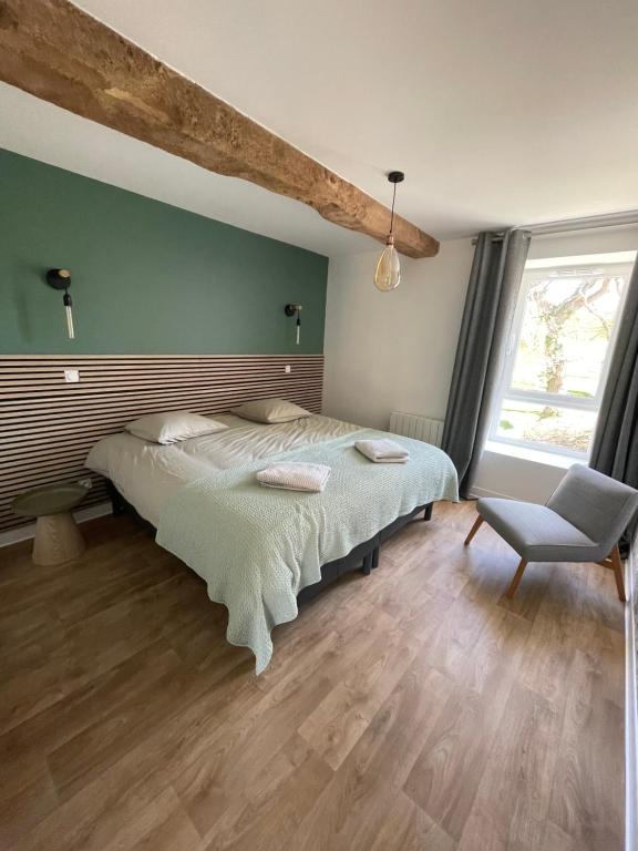 une chambre avec un lit et une chaise dans l'établissement Gite du Douet de moulagny, à Mosles