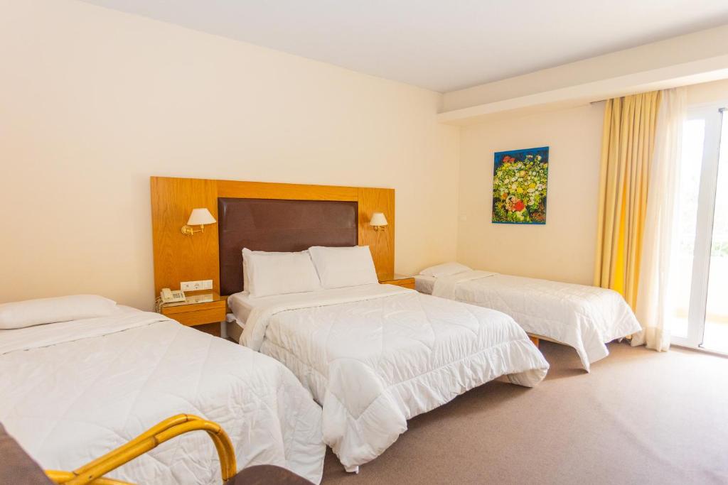 Postel nebo postele na pokoji v ubytování Hotel Aspassia