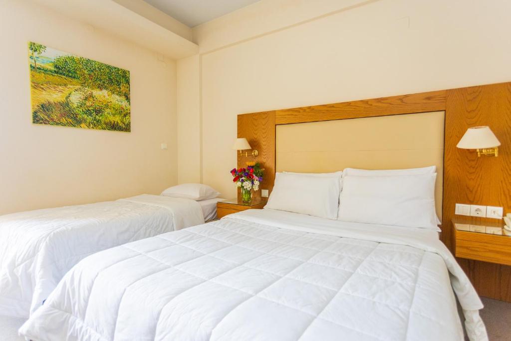 Postel nebo postele na pokoji v ubytování Hotel Aspassia