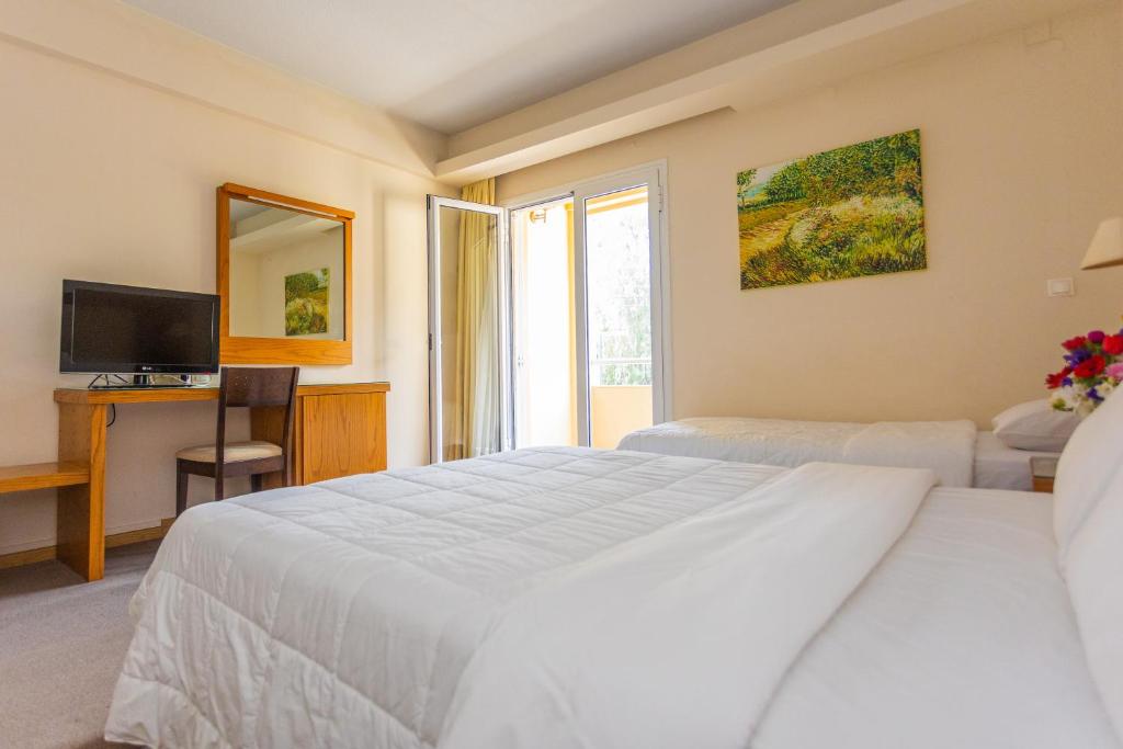 Postel nebo postele na pokoji v ubytování Hotel Aspassia