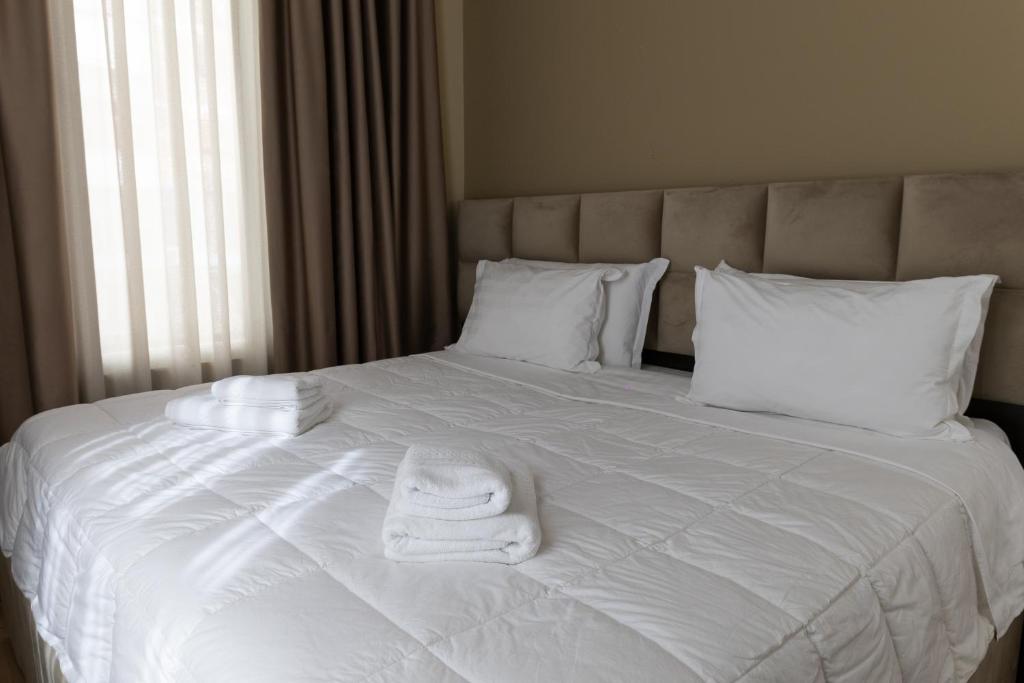 Postel nebo postele na pokoji v ubytování 4R Colombo Hotel