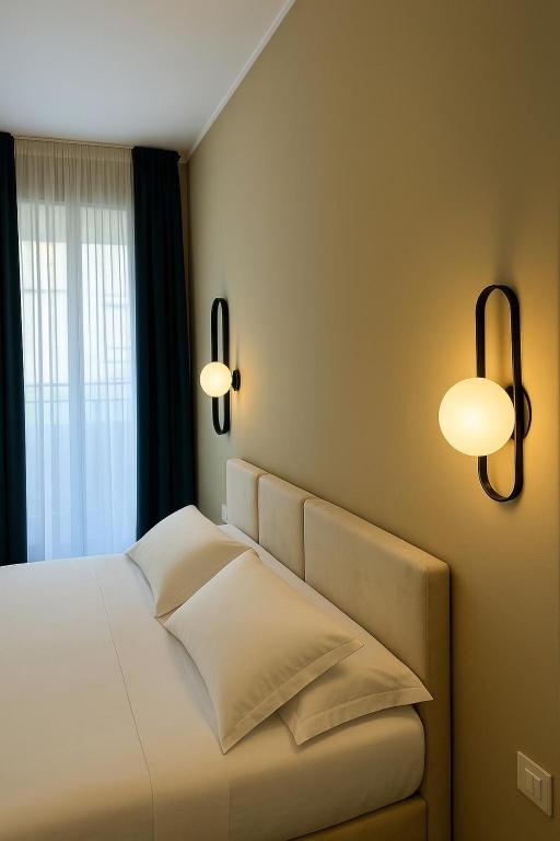 Postel nebo postele na pokoji v ubytování Maison ì room & suites