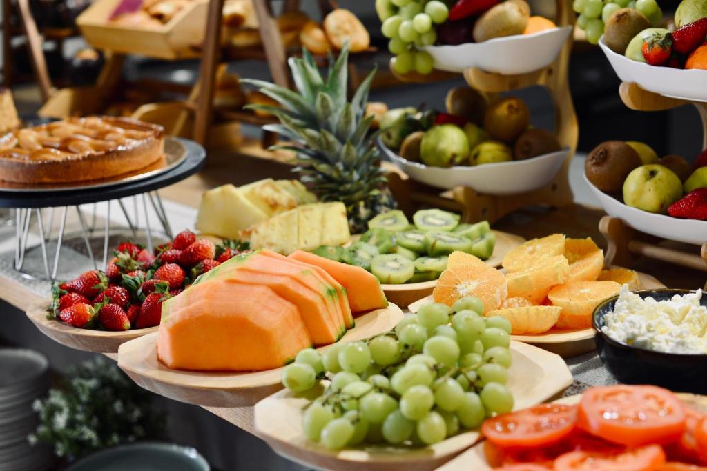 a buffet of different types of fruits and vegetables at Palermo Inn Boutique Arte in Palermo