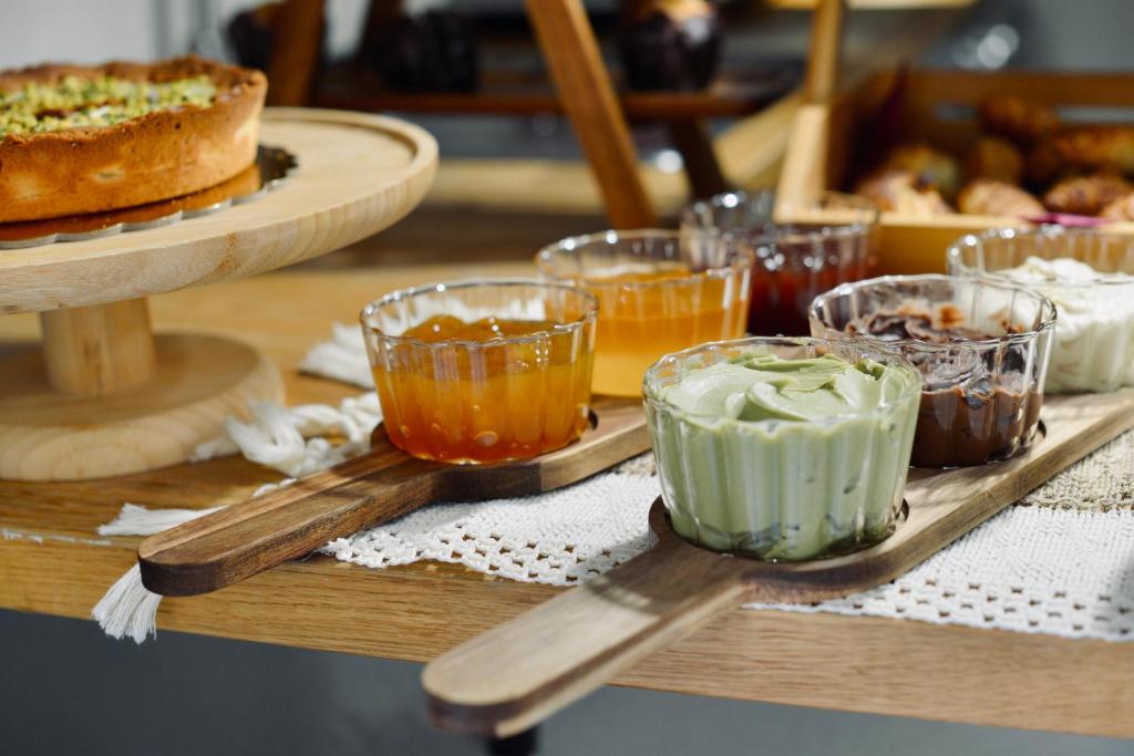 a table topped with different types of desserts on trays at Palermo Inn Boutique Arte in Palermo
