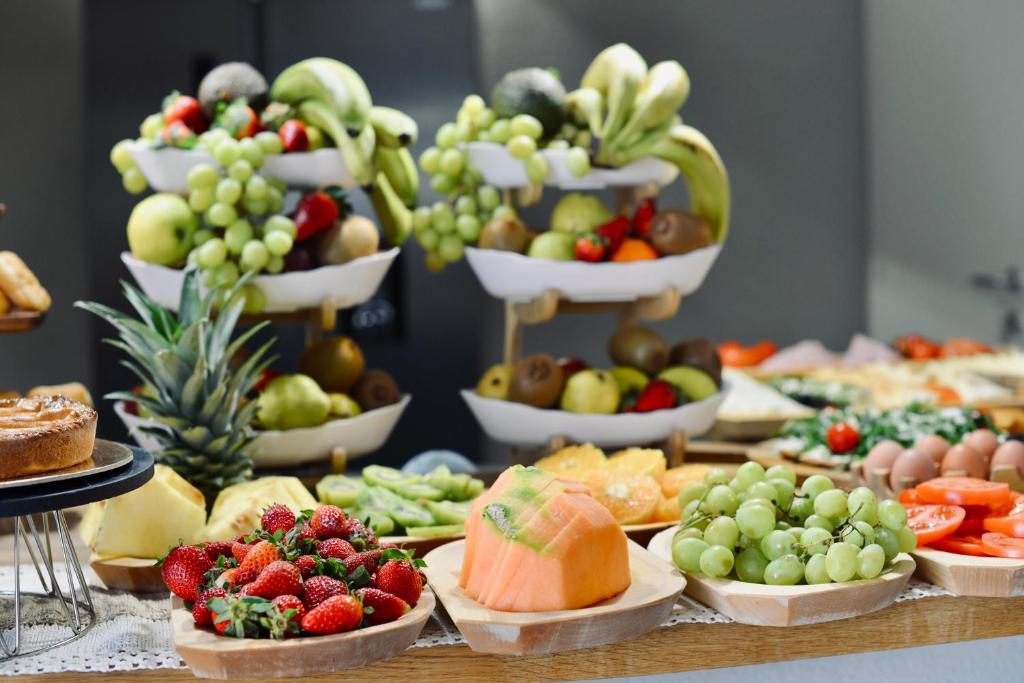 a table topped with lots of different types of fruits and vegetables at Palermo Inn Boutique Arte in Palermo
