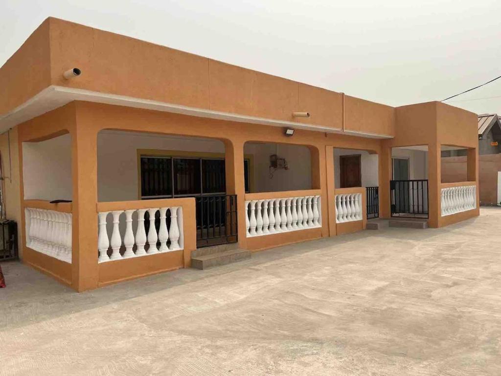 a small building with a lot of windows at Cozy 2 bedroom apartment in Accra