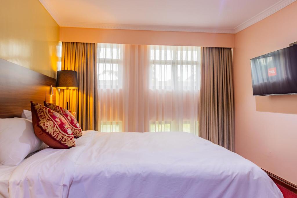 Postel nebo postele na pokoji v ubytování Karen Plains Hotel Nairobi