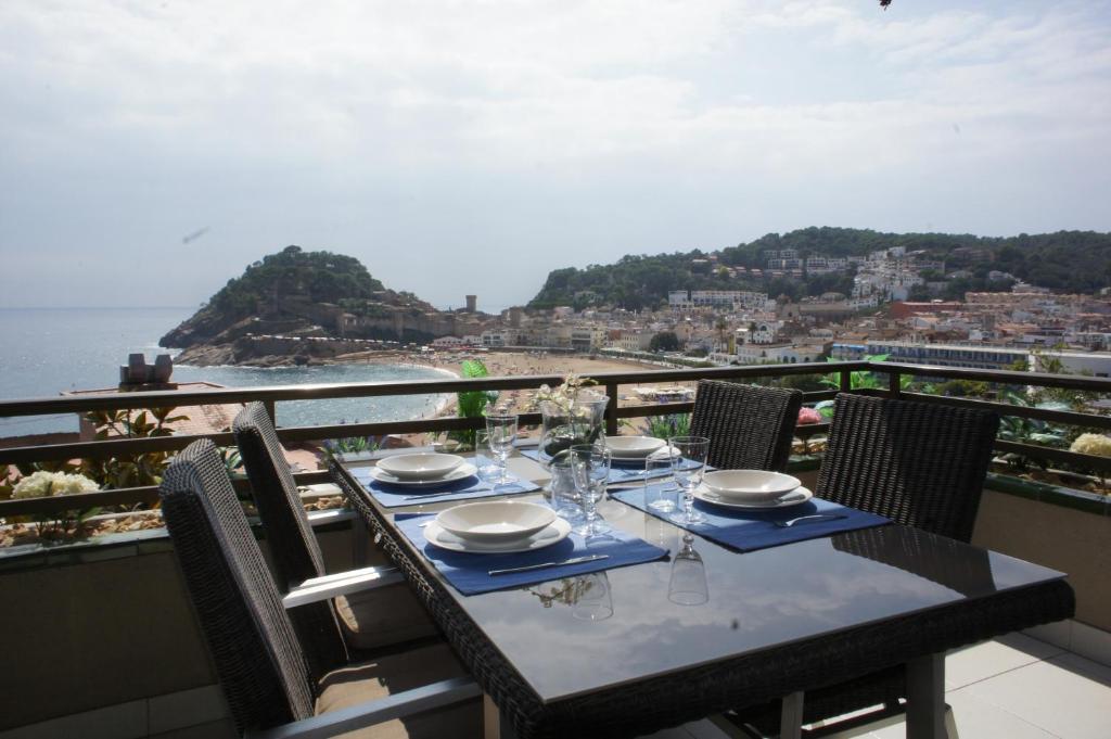 a table on a balcony with a view of the ocean at Girbal Terrace in Tossa de Mar