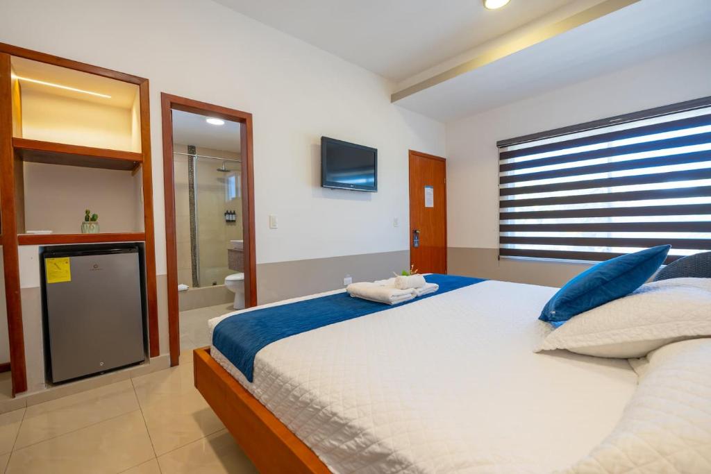 Postel nebo postele na pokoji v ubytování Hotel Ninfa