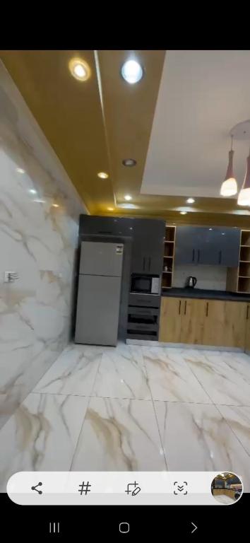 a kitchen with white marble floors and a counter top at شقه فندقيه بالمهندسين in Cairo